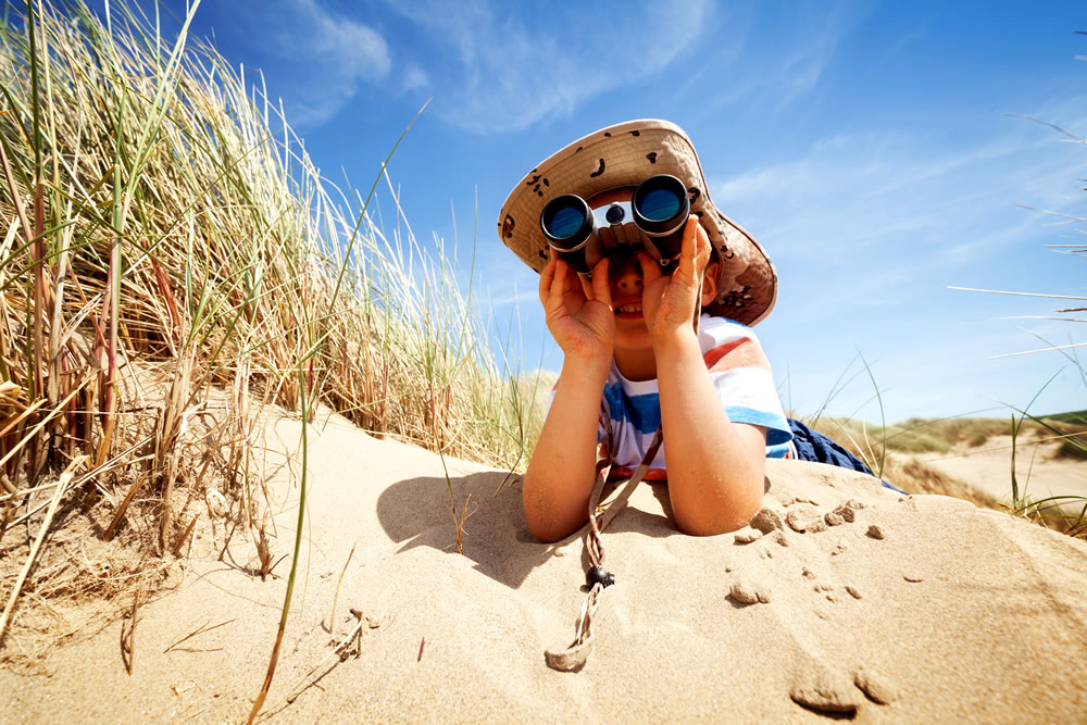 Boy looking through binoculars